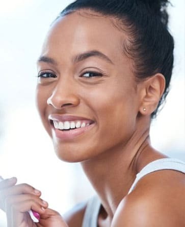 Smiling woman showing healthy teeth and bright smile after dental treatment.