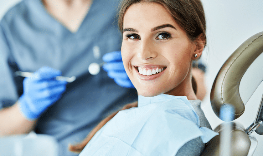 Happy patient smiling at dental chair after advanced treatment in Niceville, FL.