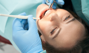Patient receiving dental treatment with dentist using professional instruments in Niceville.