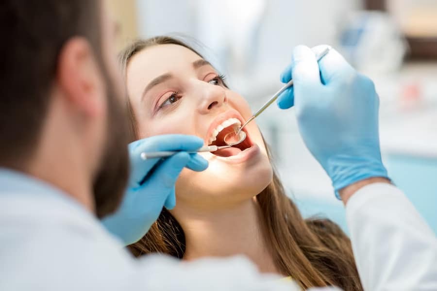 Dentist examining patient's teeth during cosmetic dental treatment in Niceville.