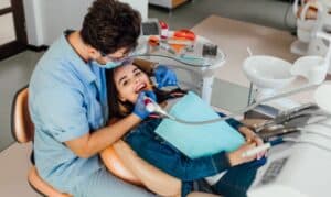 Dentist examining patient's teeth during emergency dental treatment in Niceville.
