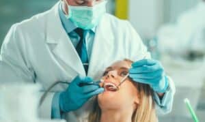 Dentist examining patient's teeth during dental treatment in Niceville.