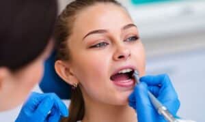 Dentist examining patient's teeth during cosmetic dental treatment in Niceville.