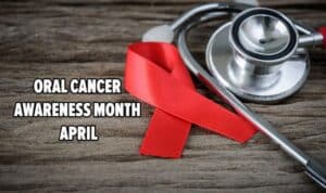Red ribbon and stethoscope symbolizing Oral Cancer Awareness Month in April.