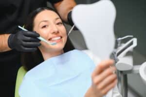 Patient smiling during cosmetic dental restoration treatment with dentist in Niceville, Florida.