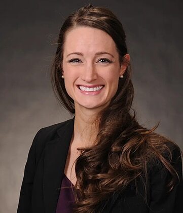 Professional female dentist smiling at Niceville dental practice.