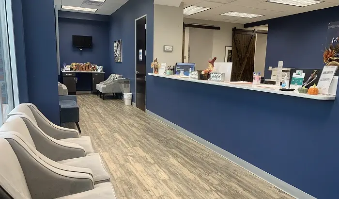 Modern dental office waiting room with comfortable seating and reception desk in Niceville, Florida.